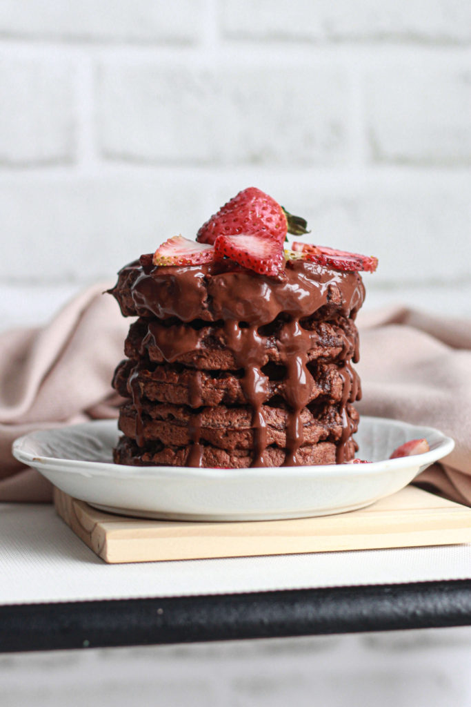 showing chocolate waffles stack with strawberries