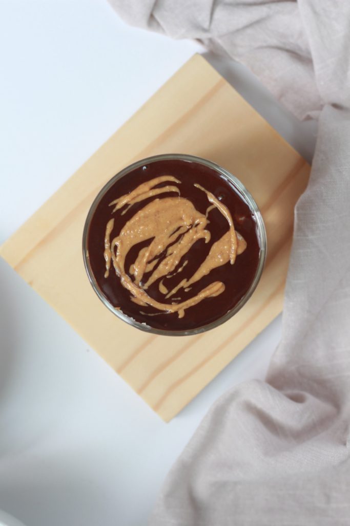 showing peanut butter on top of chocolate ganache