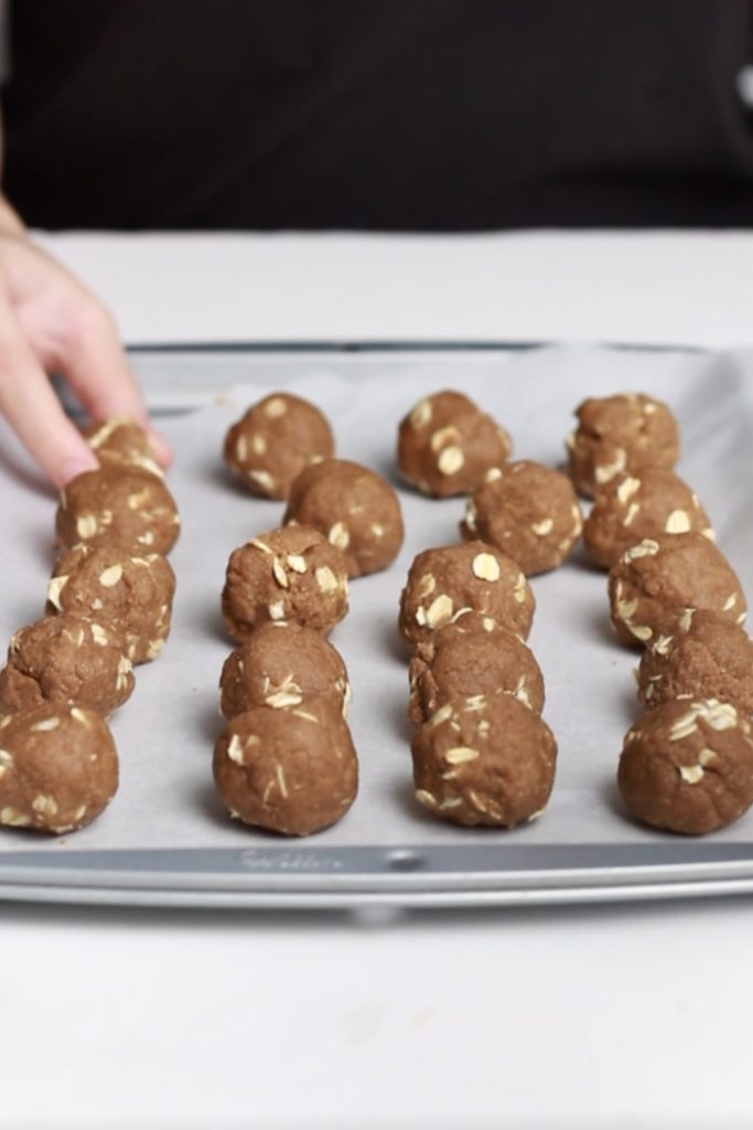 showing oatmeal ginger balls raw in the tray before baking